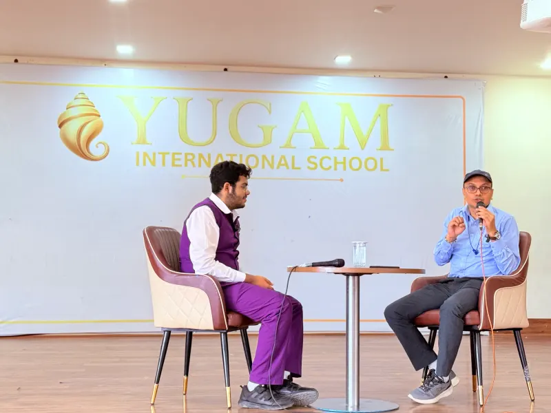 Host and guest on stage for Episode 18 of Samvaad at Yugam International School